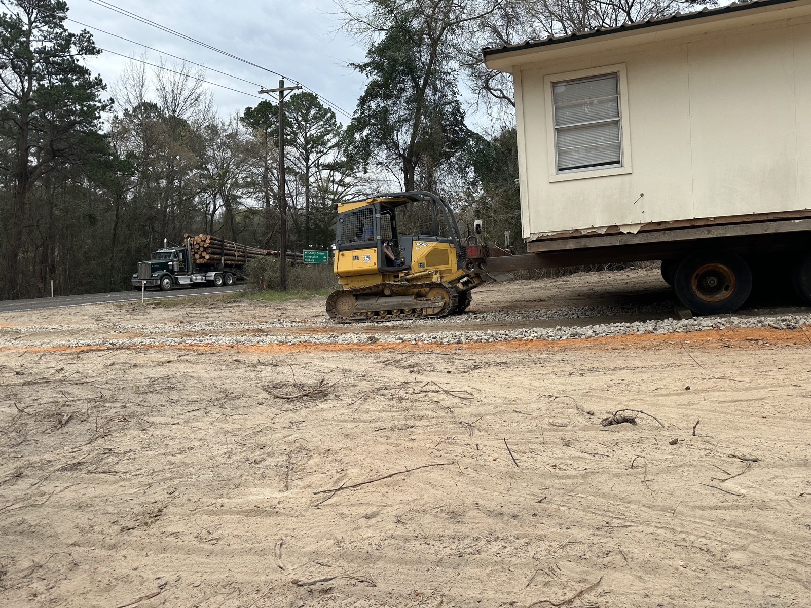 Dozer pushing a house moving truck up a hill in Pine Mills, Texas