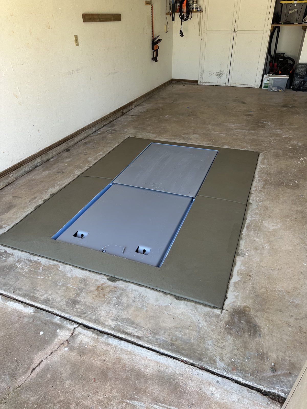 Finished in ground storm shelter in a garage floor in East Texas