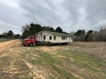Little frame house loaded on a moving truck near Pine Mills, Texas