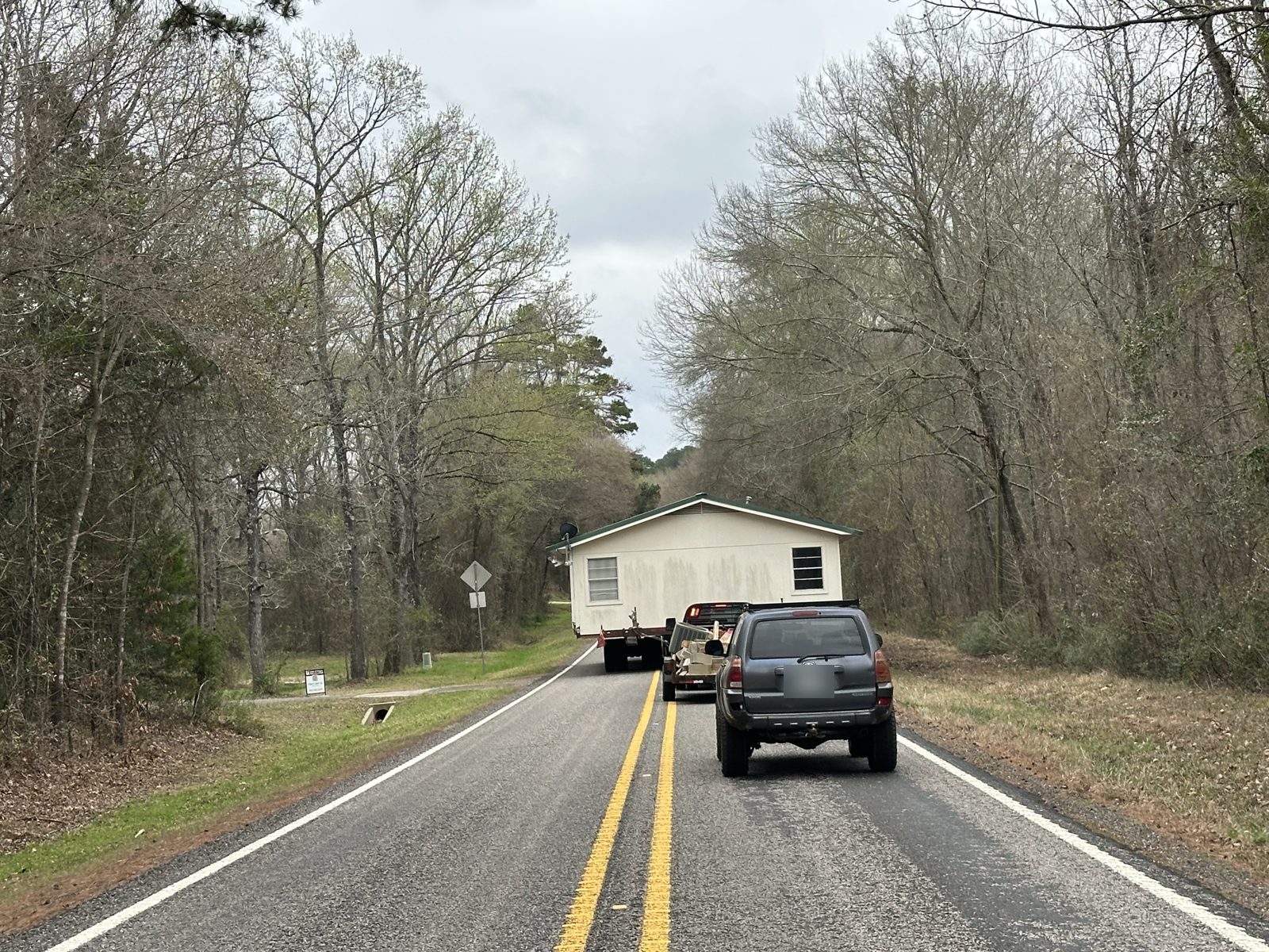 Following a house move on a two lane road near Pine Mills, Texas