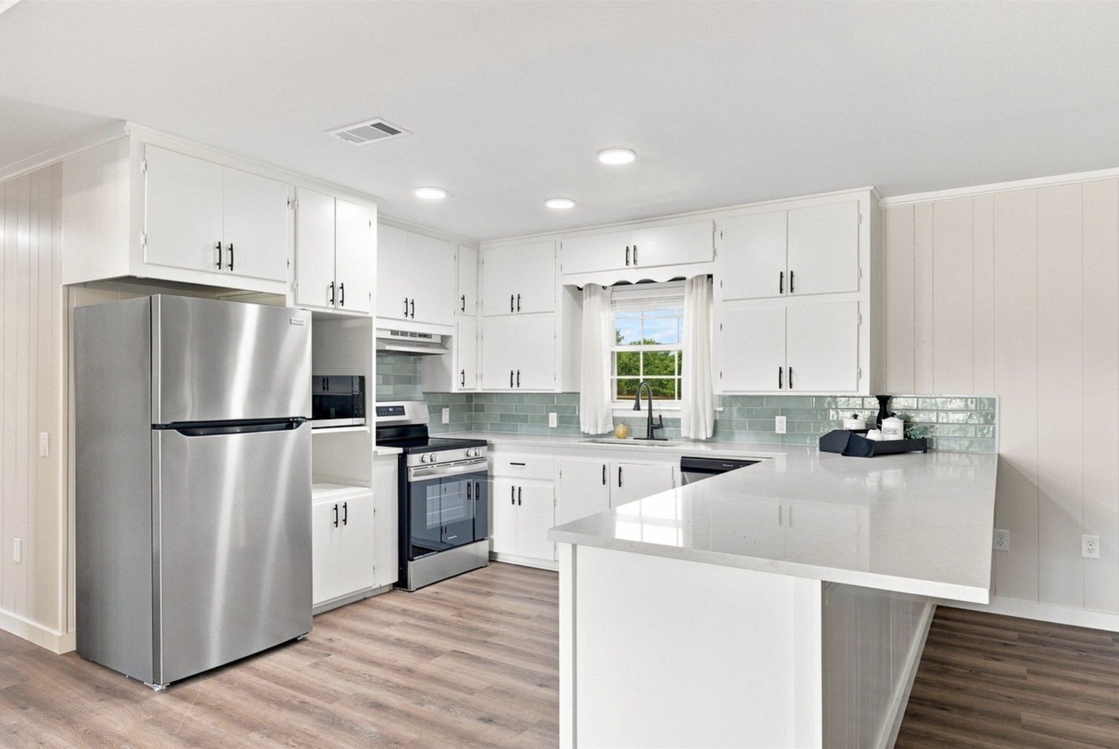 New white kitchen with stainless appliances
