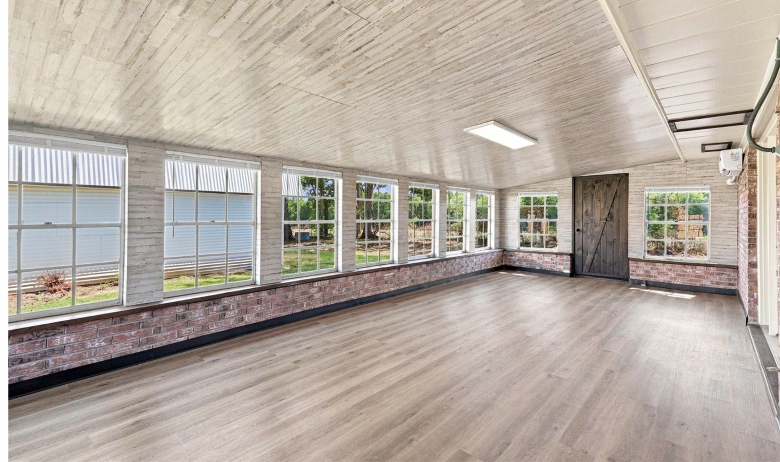 Remodeled sunroom with new windows and flooring