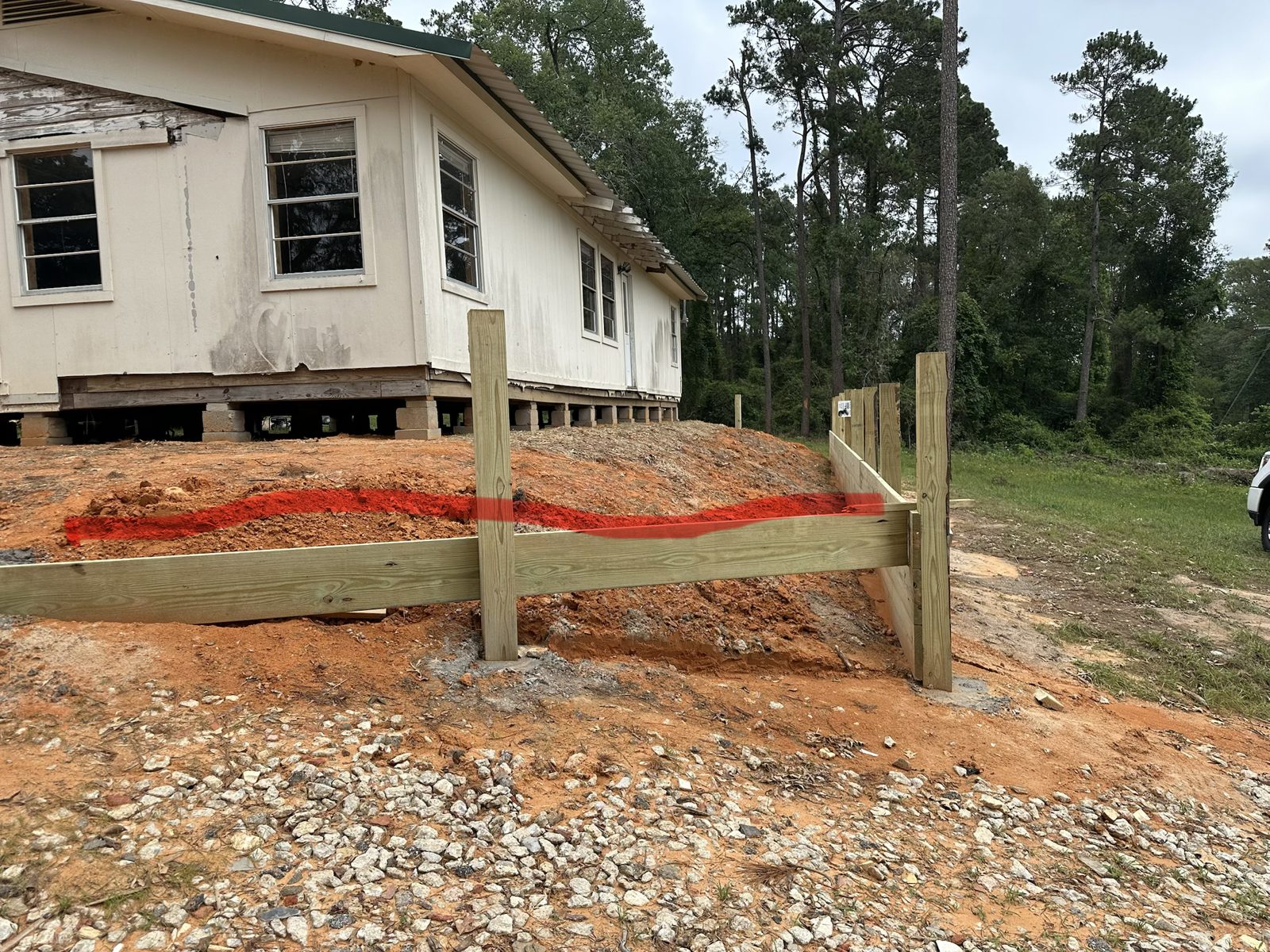 Retaining wall going in on a sloped lot in Pine Mills, Texas