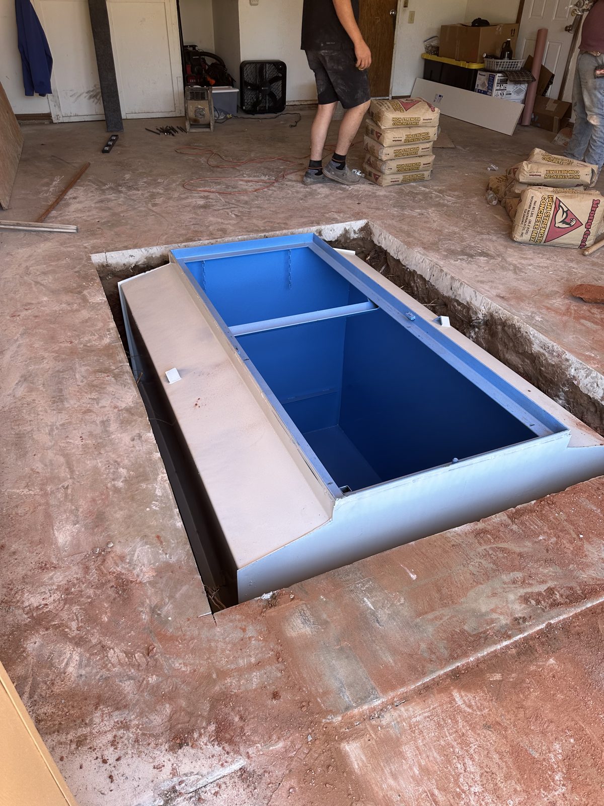 In ground storm shelter set into a garage floor in East Texas