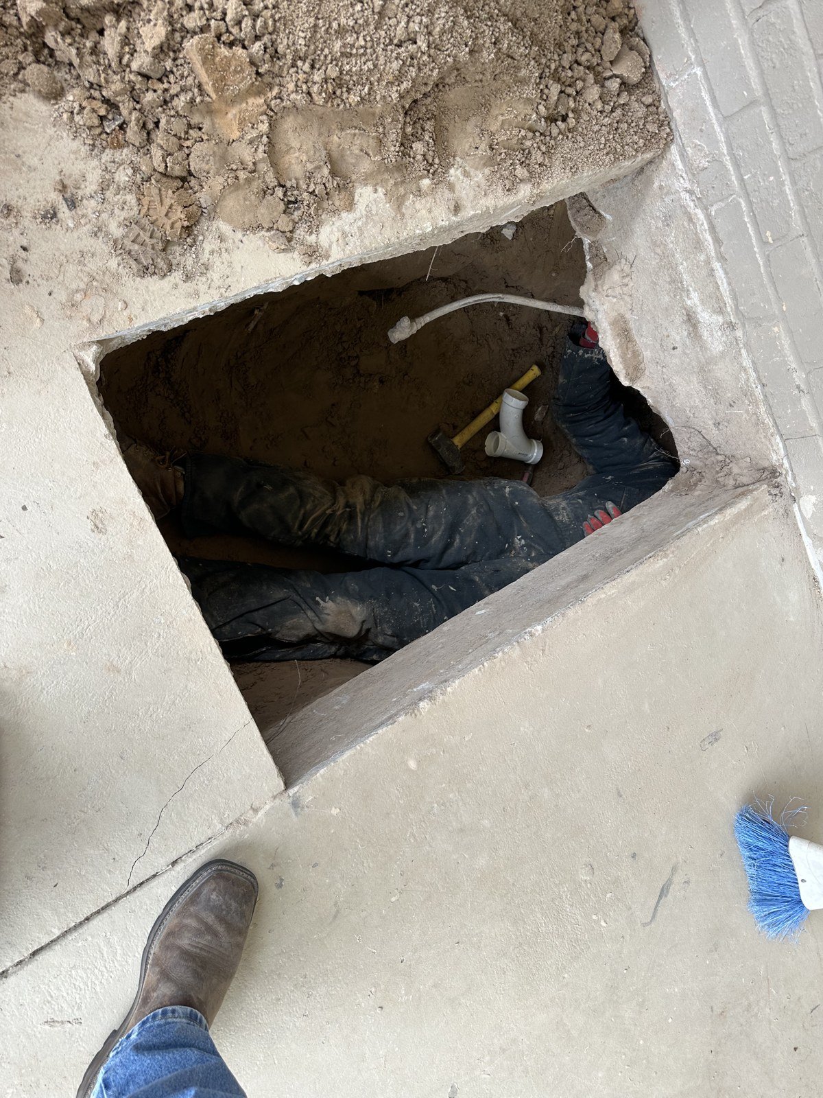 Access hole for a plumbing tunnel under a house